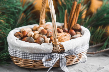 Christmas Concept Basket with Assorted Mixed Nuts Walnuts Hazelnuts Pine Branch Yellow Blanket Cozy Healthy Concept Autumn Winter Background