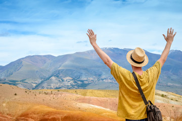 Freedom traveler man standing with raised arms and enjoying beautiful nature