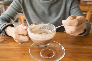 hands holding hot cup of coffee or tea