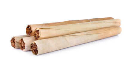 Tobacco pile and cigarette on white