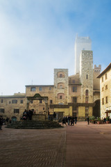 Fototapeta na wymiar The beautiful main square of San Gimignano, a little medieval town in tuscany. In the center of this wide space there still is the old well