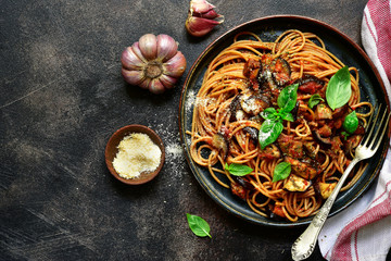 Spaghetti alla norma - traditional italian pasta with eggplants and tomato. Top view. - obrazy, fototapety, plakaty