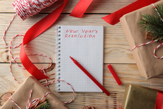 New Year. Christmas. Holidays. Composition with New Year and Christmas gifts and the New Year's resolution form. View from above