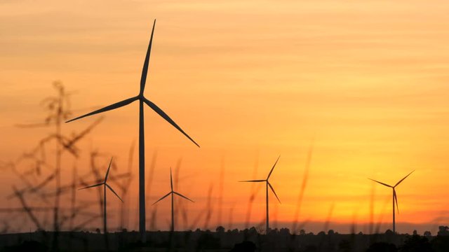 Silhouette of wind turbine over sunset ecology energy concept for electric maker the technology of alternate clean power form wind