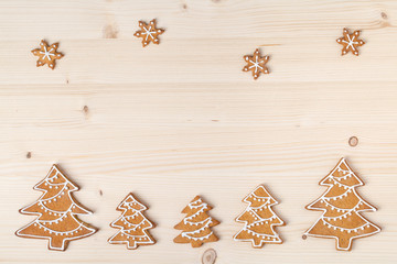 christmas homemade gingerbread cookies on wooden background with empty copy space for text. snowflake and star shapes. holiday, celebration and cooking concept. new year and christmas frame