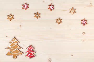 christmas homemade gingerbread cookies on wooden background with empty copy space for text. snowflake and star shapes. holiday, celebration and cooking concept. new year and christmas frame