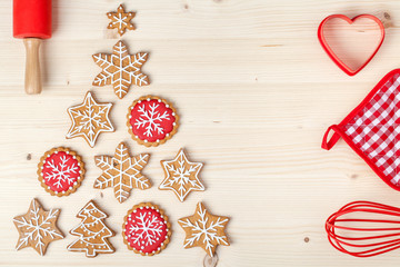 baking tools and christmas tree made from homemade gingerbread cookies on wooden background with empty copy space for text. holiday, celebration and cooking concept. new year and christmas postcard