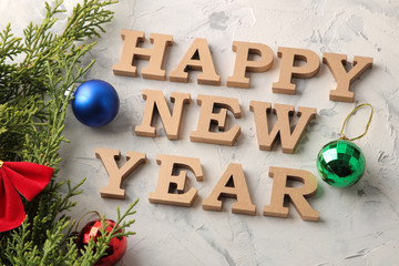New Year 2019. Holidays. Composition with the inscription happy new year with a Christmas tree and New Year balls. on a light background