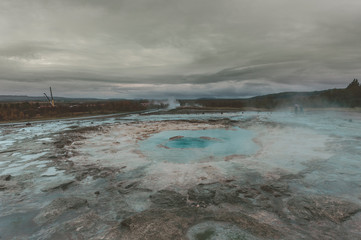 Strokkur (churn) fountain geyser in the geothermal area beside the Hvítá River. Haukadalur, Geysir - Iceland
