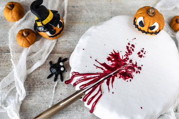 halloween cake splattered with fake blood and decorated with sugar paste; pumpkins that laugh