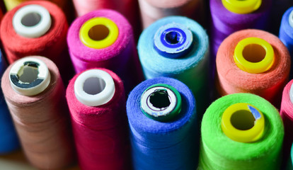 Sewing threads as a multicolored background closeup