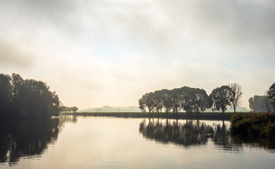 Fototapeta premium Color photo of a misty autumn morning at the lake