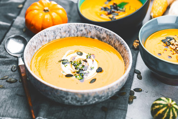 Roasted pumpkin and carrot soup with cream and pumpkin seeds 