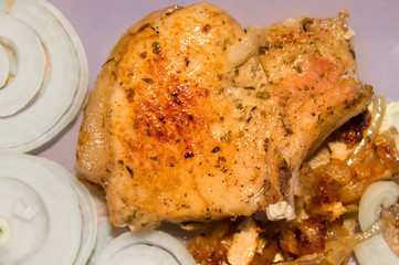 Fried chicken with spices and onion rings close up