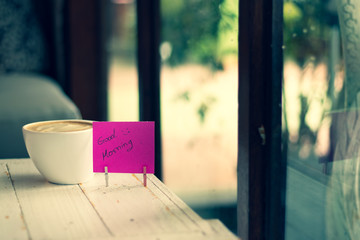 Hot coffee and paper note with good morning.