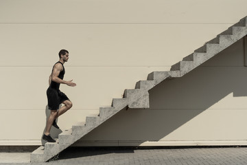 Concept of success and achieving your goal, man climbing stairs.