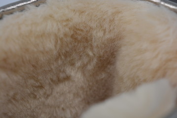 Warm fur, yellow plush from synthetics and wool of light color inside the women's boot, texture and background