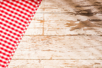 Checkered napkin on wooden background. Top view