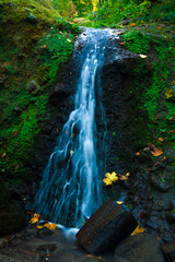 A waterfall in mountain range autumn