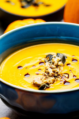 Roasted pumpkin and carrot soup with cream and pumpkin seeds 