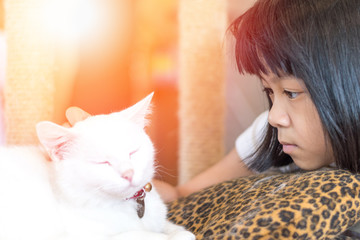Asia child with autism spectrum disorder (ASD),kid girl playing with Siamese white cat for pet therapy.