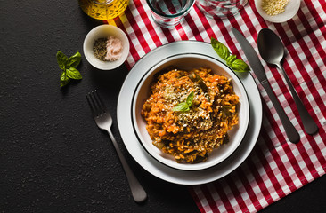 Italian risotto with tomato sauce on the table.