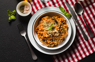 Italian risotto with tomato sauce on the table.
