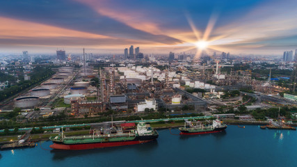 Fototapeta premium Oil refinery factory and tanker boat with beautiful sky at dusk for energy or gas industry or transportation background.