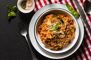 Italian risotto with tomato sauce on the table. copy space