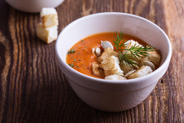 Butternut squash soup  in bowl topped with croutons