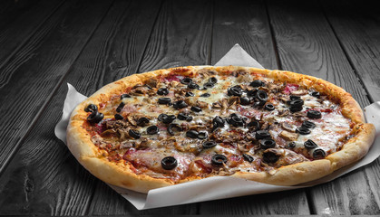 traditional italian pizza on dark black wooden board
