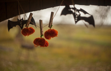 garland of papercut bats and yarn pumpkins hanging in old wooden gazebo