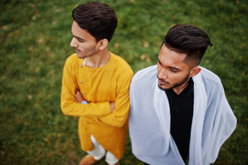 Fototapeta premium Two indian stylish mans friends in traditional clothes posed outdoor, view from above.