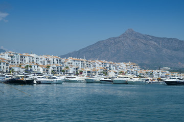 Fototapeta na wymiar Puerto Banus, Marbella, Costa del Sol, Spain. Whitewashed buildings and shops serve as a backdrop to nthis harbour of marine vessels of all sizes from small dinghies to luxury yachts.