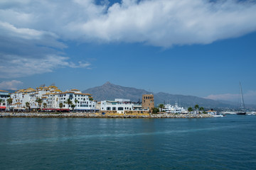 Puerto Banus, Marbella, Costa del Sol, Spain. Whitewashed buildings and shops serve as a backdrop to nthis harbour of marine vessels of all sizes from small dinghies to luxury yachts.