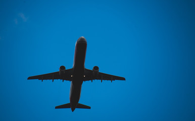 Silhouette of a plane taking off against the blue sky