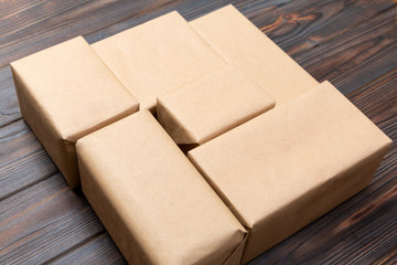 Brown mail package parcel blank for you design. Cardboard box on a dark wooden background