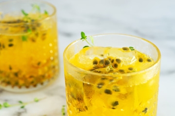 glass of passion fruit juice on marble table