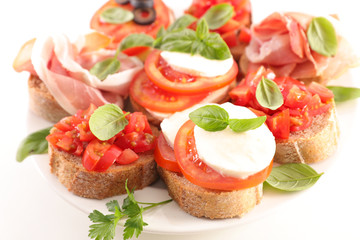canape with tomato, mozzarella and basil
