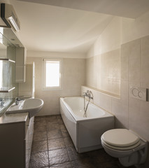 Empty bathroom with bathtub and tile