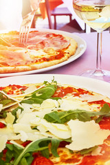 Glass of white wine and pizza Italy