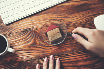 woman hand house model with magnifier