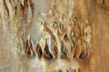Natural texture image of cute natural cave with sandy walls and formations of stalactites everywhere - Marble Cave, Crimea