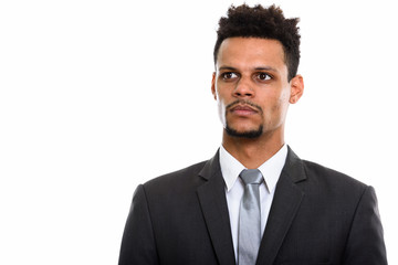 Studio shot of young African businessman thinking