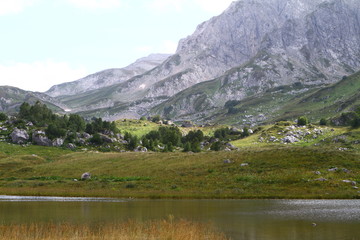 Naklejka na ściany i meble Natural landscape photo of small mountain lake Psenodah in North Caucasus at Fisht and Oshten mountains