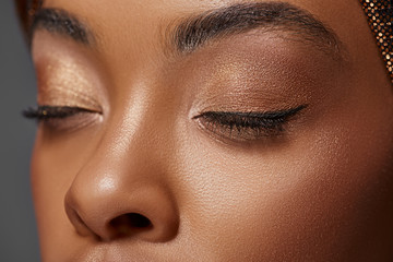 cropped shot of african american woman with eyes closed isolated on grey