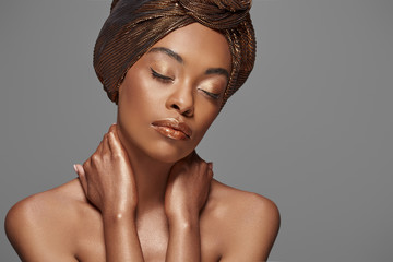portrait of beautiful african american woman with head wrap and bare shoulders isolated on grey - obrazy, fototapety, plakaty