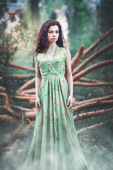 Young girl in the forest on a background of trees