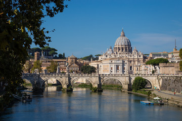 St. Peter's Basilica, the Vatican city and the tiber river in Rome against blue sky