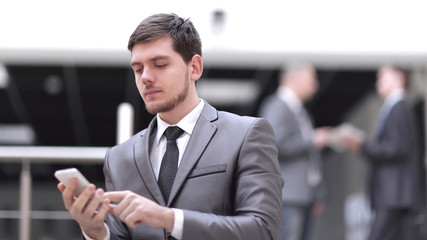 portrait of handsome businessman on blurred office background